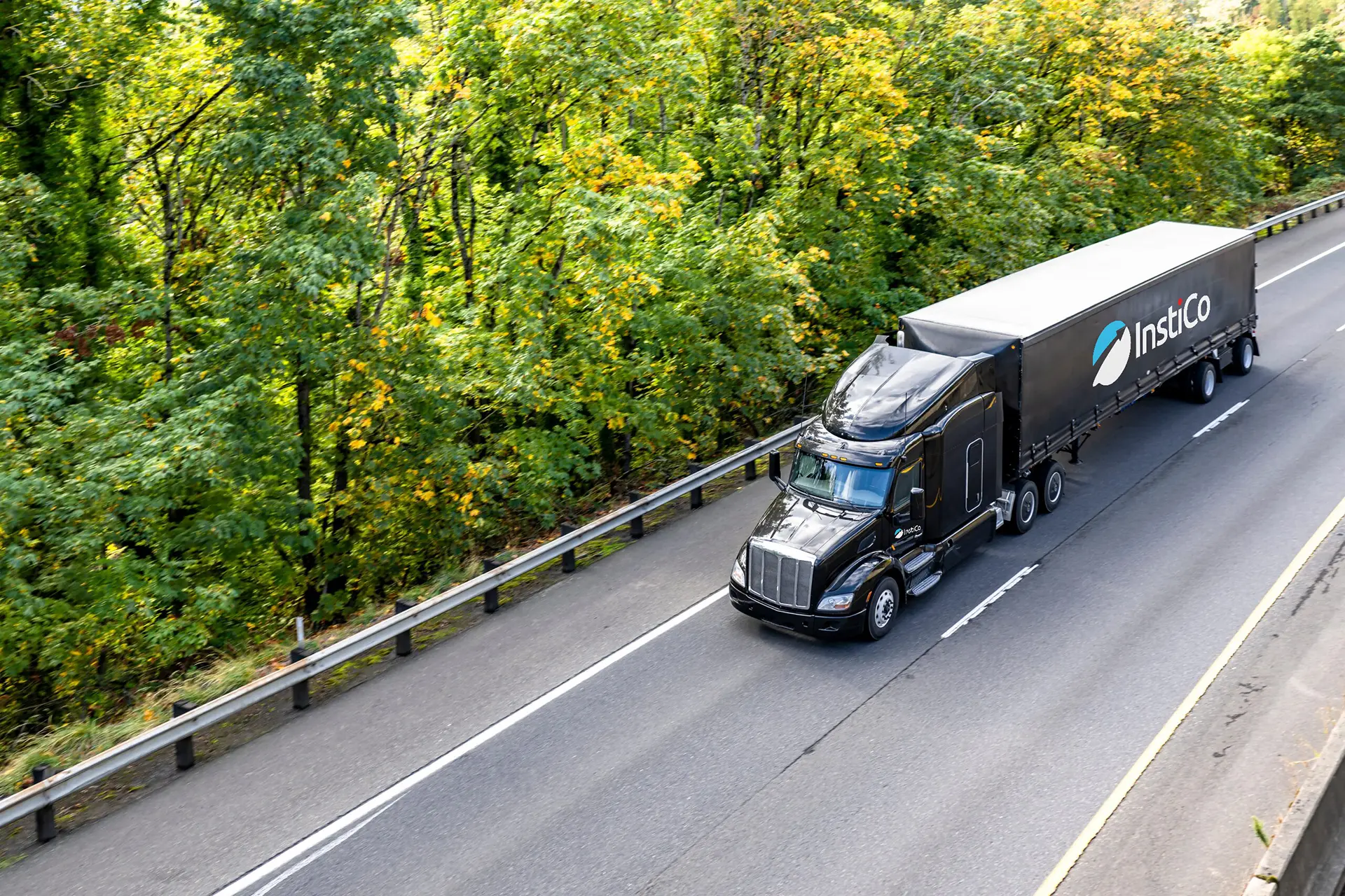 Semi-truck with flatbed trailer on coastal highway